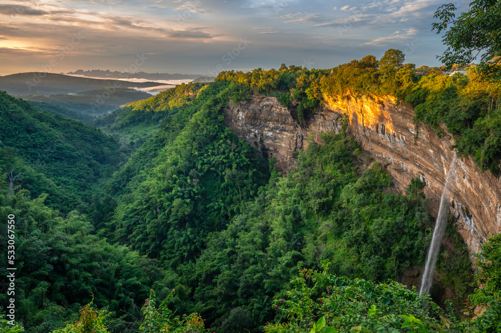 The naturally occurring rocky cliffs are covered with lush greenery on foggy days in morning. Caused by changes in the earth's crust at canyon Nam Nao in Phetchabun Province unseen Thailand.
