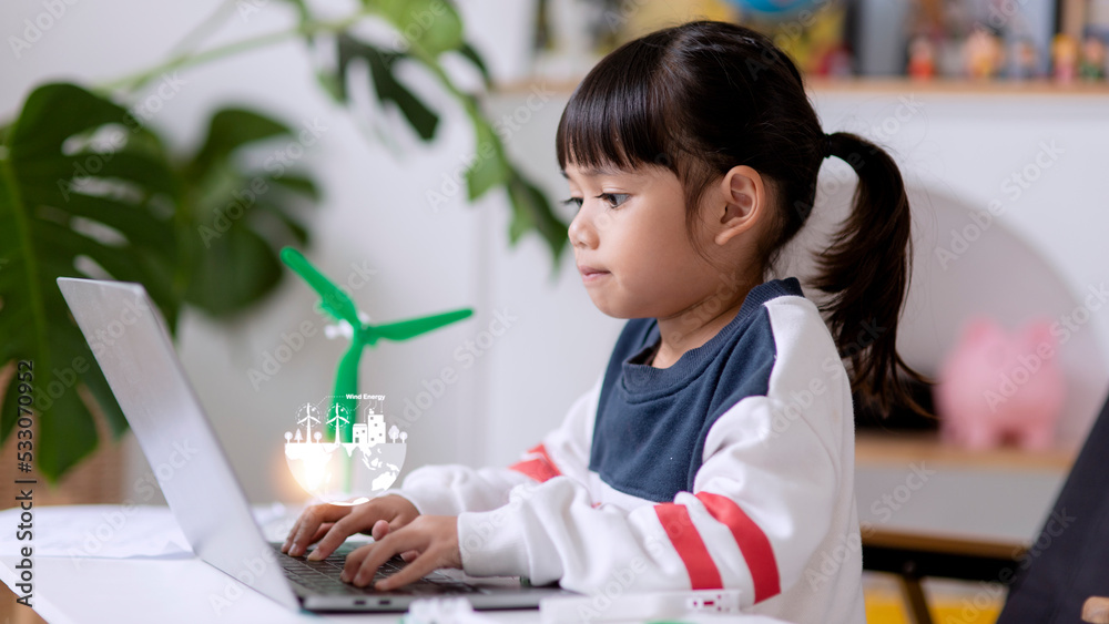 renewable energy, science, and technology concept - happy children with laptop computers, wind energy hologram,s and wind turbine models and icons. renewable energy, science, and technology concept - happy children with laptop computers, wind energy hologram,s and wind turbine models and icons.