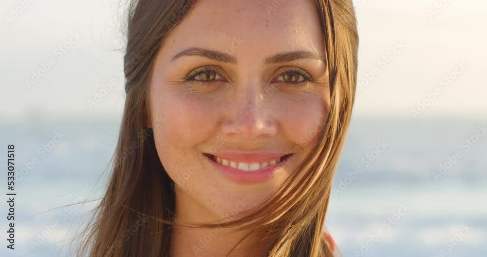Happy, portrait and face of woman at the beach with a smile during a summer vacation. Attractive, beauty and happiness with cheerful female with an ocean background in nature feeling positive outdoor Happy, portrait and face of woman at the beach with a smile during a summer vacation. Attractive, beauty and happiness with cheerful female with an ocean background in nature feeling positive outdoor