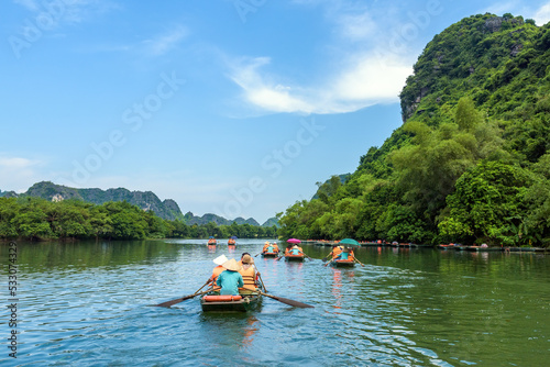 Rowing boats carrying tourists on the river in Trang An, Ninh Binh province, Vietnam. Trang An is a world cultural and natural heritage recognized by UNESCO