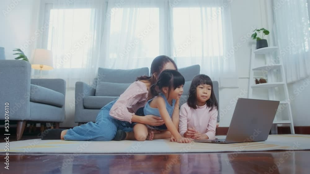 Asian family with children using laptop computer at home Asian family with children using laptop computer at home