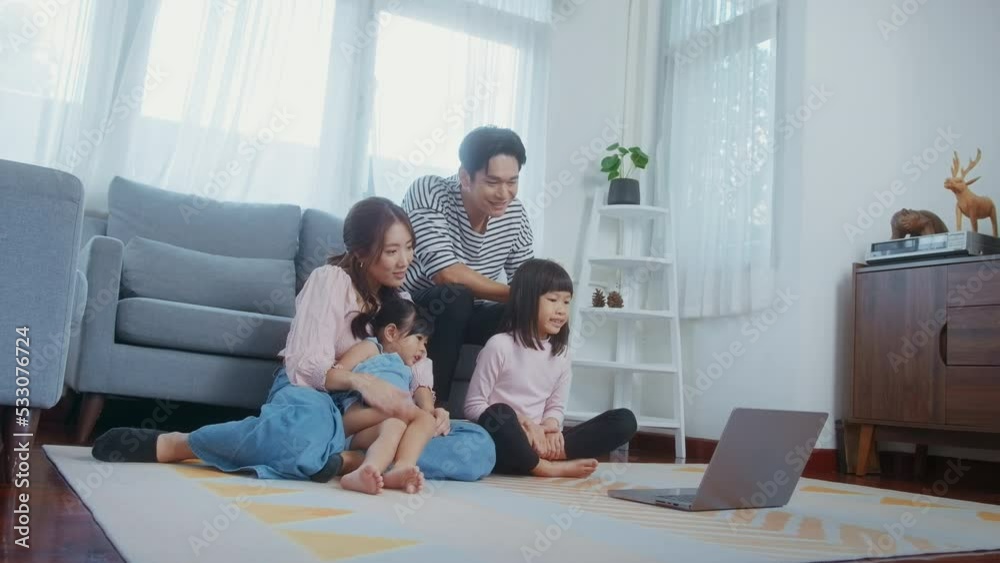 Asian family with children using laptop computer at home Asian family with children using laptop computer at home