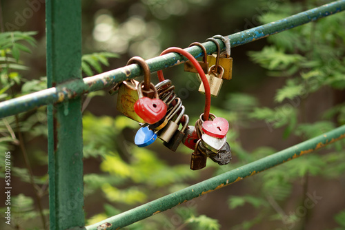 tradition of love to hang a padlock on a bridge. Red heart lock