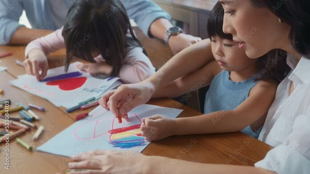 Asian family with children Drawing and painting on table in playing room at home, Educational game. Asian family with children Drawing and painting on table in playing room at home, Educational game.