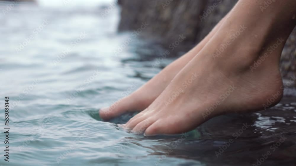 Feet of woman, dip in ocean or sea on vacation, trip or summer holiday. Relax, paradise and barefoot girl relaxing with foot in river, lake or body of water for peace, calm and relaxation outdoors.