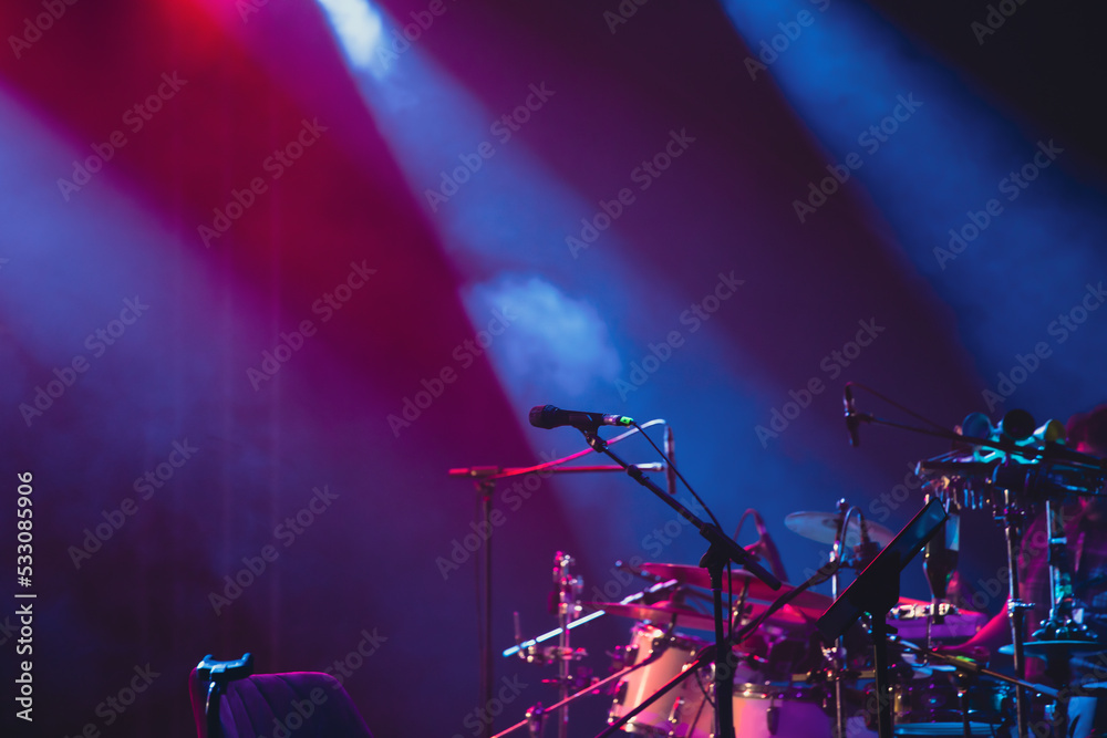 Colorful stage lights and microphone at concert