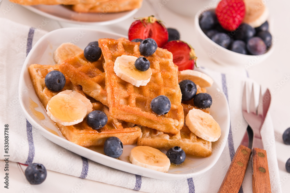Waffles with blueberries, bananas and honey. Waffles with blueberries, bananas and honey.
