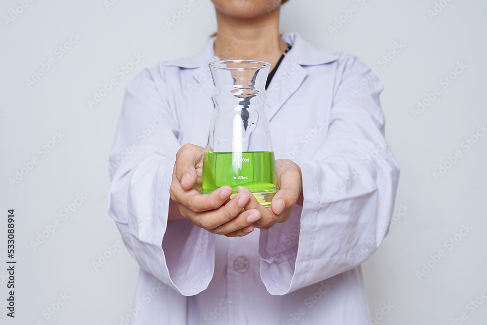 Close-up of scientist in a white lab coat with chemical glassware isolated over white background. Close-up of scientist in a white lab coat with chemical glassware isolated over white background.