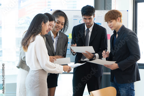 Young people group in modern office have discussion of a new project photo