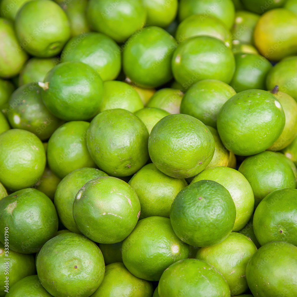 Limes close-up on background in supermarket Limes close-up on background in supermarket