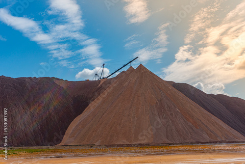 Mining industry close up. Telestacker handles the ore closeup for potash waste heaps, extraction of salt and potash fertilizers in a quarry and processing of ore photo