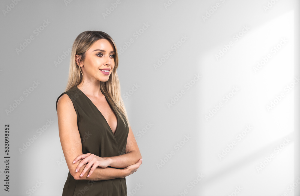 Attractive businesswoman wearing formal wear standing in crossed Attractive businesswoman wearing formal wear standing in crossed
