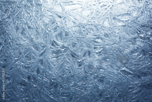 The texture of the ice surface. Winter background  festive background in the form of ice crystals  in natural deep blue color.
