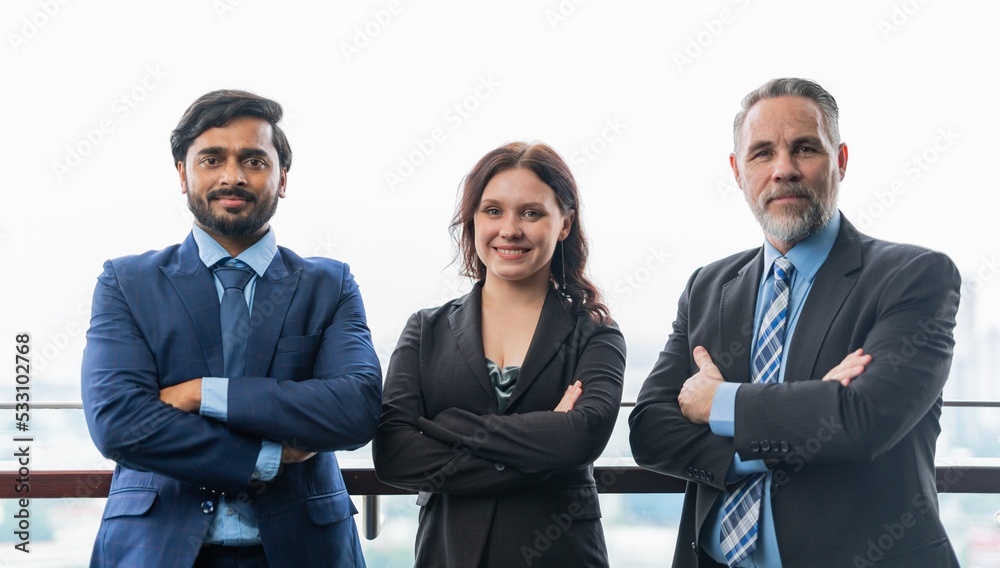 Portrait photo of a team of asian and caucasian businessmen and businesswoman holding up to themselves in a professional pose and gesture Portrait photo of a team of asian and caucasian businessmen and businesswoman holding up to themselves in a professional pose and gesture