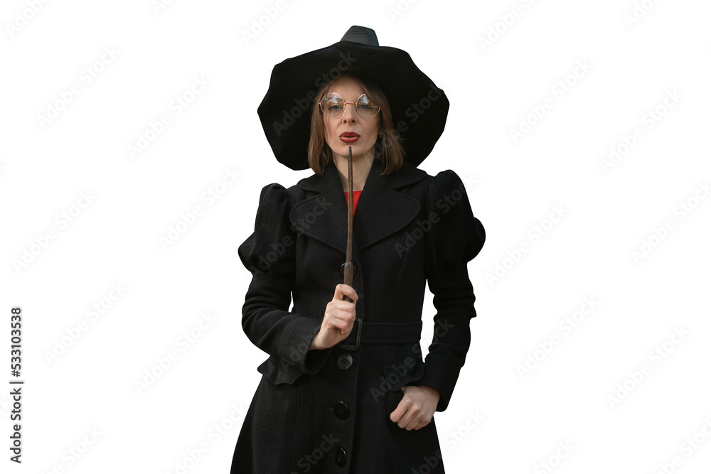 Mysterious woman in black hat, coat and with magic wand. Celebrating halloween in witch costume. Space for text Mysterious woman in black hat, coat and with magic wand. Celebrating halloween in witch costume. Space for text
