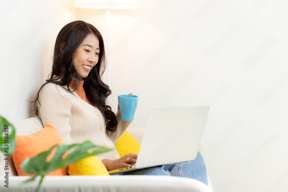 Happy young woman working and meeting online at home. Lifestyle freelance relax and chill drinking coffee in living room, Nature garden background. Lifestyle Concept Happy young woman working and meeting online at home. Lifestyle freelance relax and chill drinking coffee in living room, Nature garden background. Lifestyle Concept