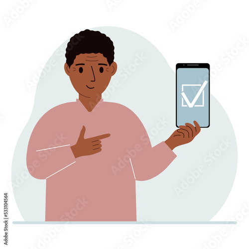 A man is holding a phone with a check mark on the screen. The concept of choice, voting or defence.