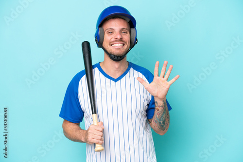 Baseball player with helmet and bat isolated on blue background counting five with fingers