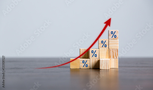 Closeup wood cubes with percentage symbol, Percent and upwards increasing arrows on wooden cubes. Financial interest mortgage rates increase or price commission raise, growth business, finance tax.