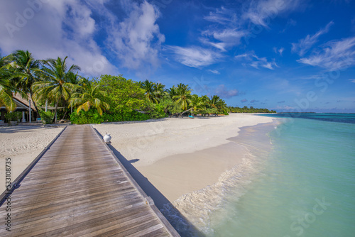 Idyllic tropical beach landscape for background or wallpaper. Wooden pier, paradise island, summer vacation landscape holiday destination concept. Exotic island, relaxing view. Paradise seaside lagoon © icemanphotos