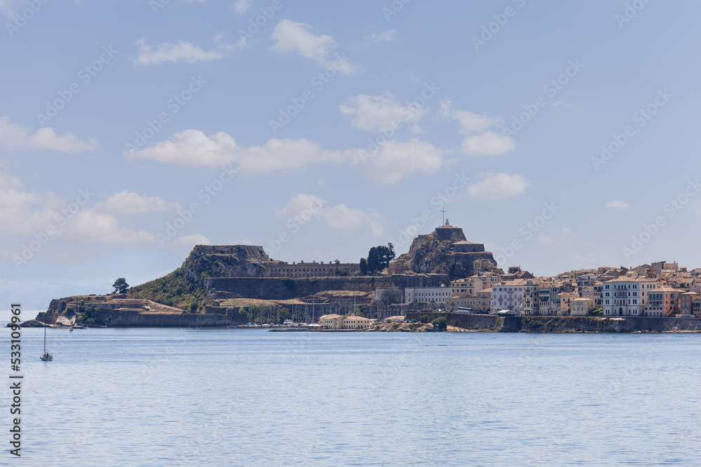 Legendary two-leveled Old Fortress of Corfu Island with twin bastions of pentagonal shape and embankment of the main port Kerkira, Greece, bright summer day