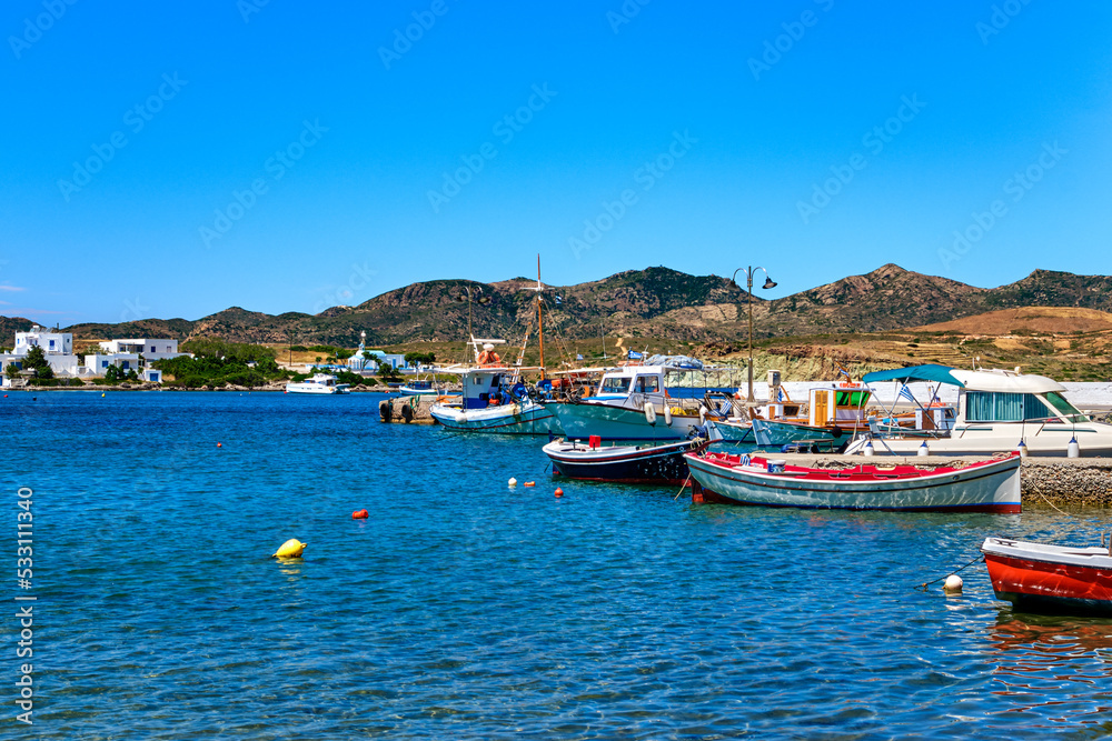 Beautiful summer day on Greek island, Milos, Greece. Fishing boats at