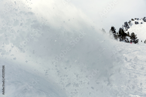 Freerider snowboarder moving down in snow powder photo