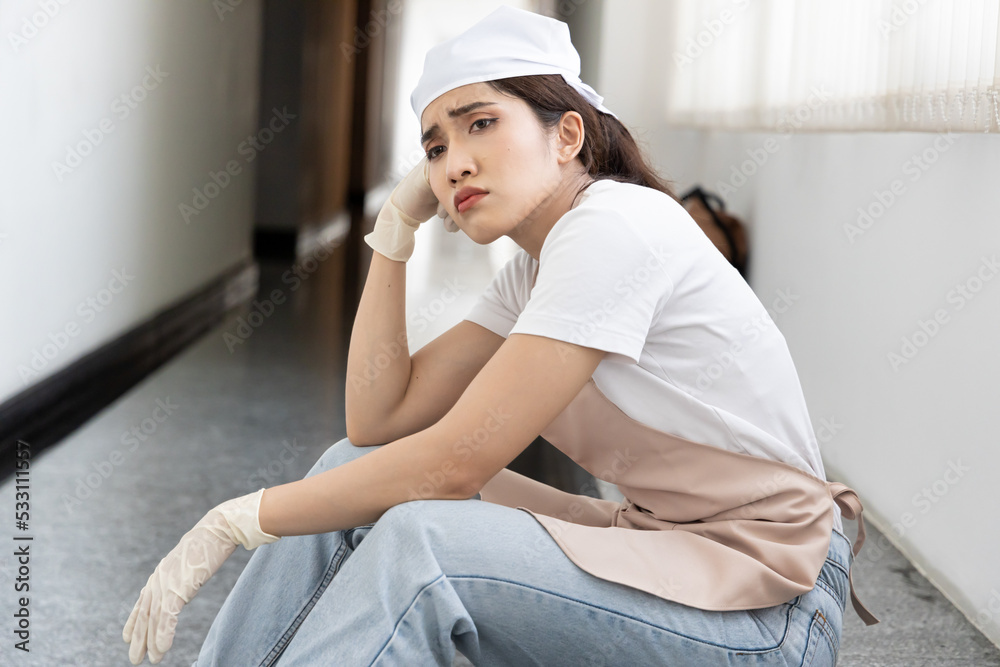 Stressed tired low wage immigrant worker, woman cleaner feeling unhappy with working condition