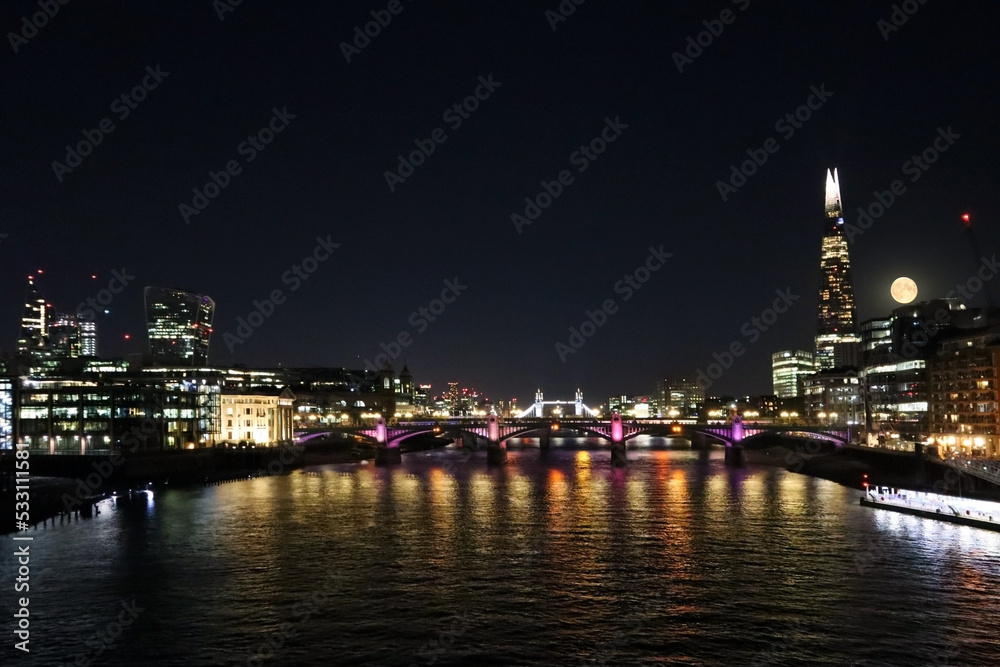 View of night London at full moon, Thames, Tower Bridge and Cheesegrater building