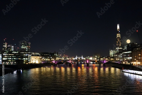 View of night London at full moon, Thames, Tower Bridge and Cheesegrater building
