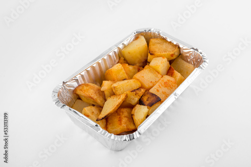 Baked potatoes served in aluminium tray