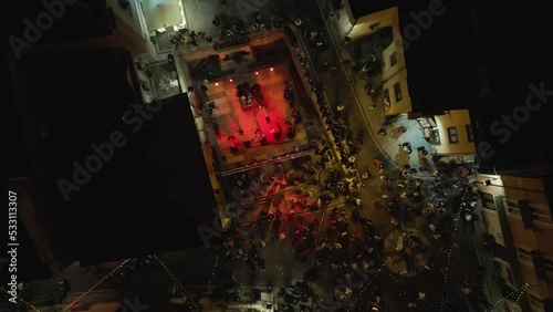 Aerial view of people playing music on stage in Ospedaletto d'Alpinolo during A Juta a Montevergine, a traditional folk festival in Avellino, Irpinia, Italy. photo