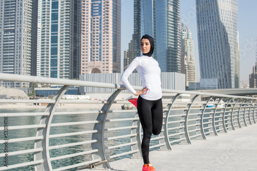 Photography Arabian woman with typical muslim dress training outdoors in Dubai - Middle-east