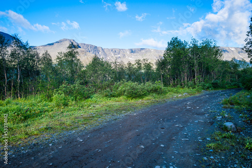 Dirt road in a mountain landscape park against the backdrop of a mountain