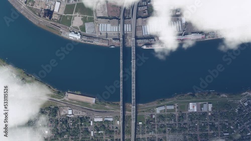 Aerial top shot flying above the clouds at Crescent City Connection in Louisiana. United States photo