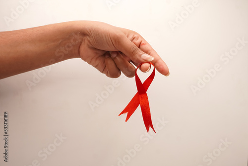 World aids day, red silk ribbon symbol of AIDS Awarenesss photo