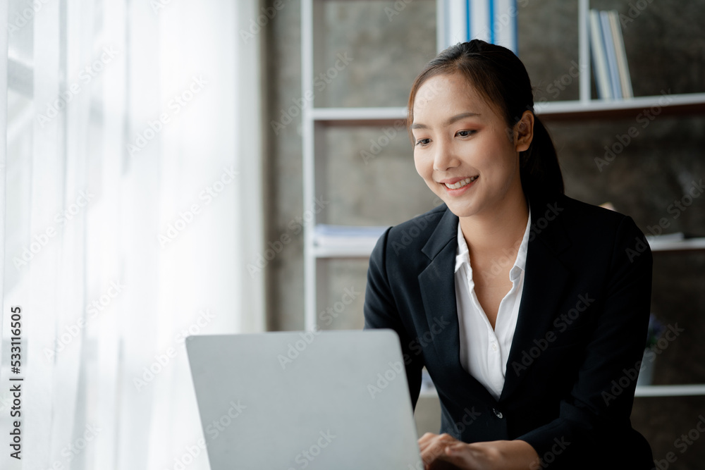 A businesswoman is checking company financial documents and using a tablet to talk to the chief financial officer through a messaging program. Concept of company financial management. A businesswoman is checking company financial documents and using a tablet to talk to the chief financial officer through a messaging program. Concept of company financial management.