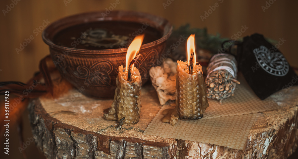 Candle burns on the altar, powerful magic among candles, energy cleaning and wicca concept	