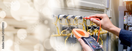 Photos Electrical engineer using measuring equipment to checking electric current voltage at circuit breaker and cable wiring system , Electrical service concept