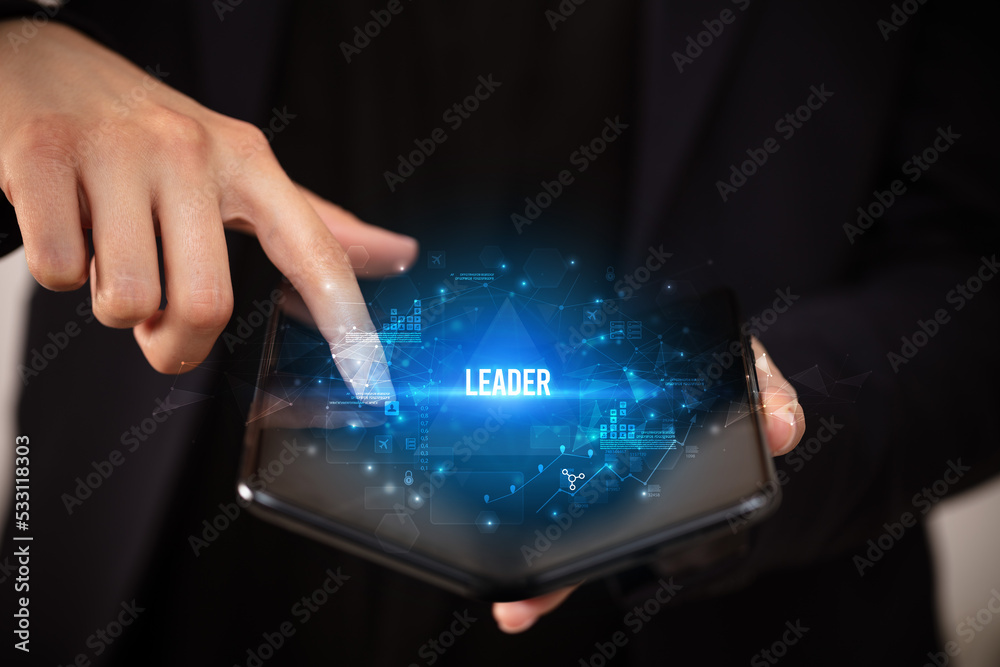 Naklejka premium Businessman holding a foldable smartphone, business concept
