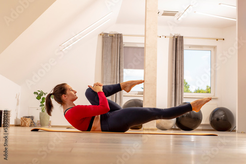 Pilates. Stretching gymnastic exercises. Woman on training