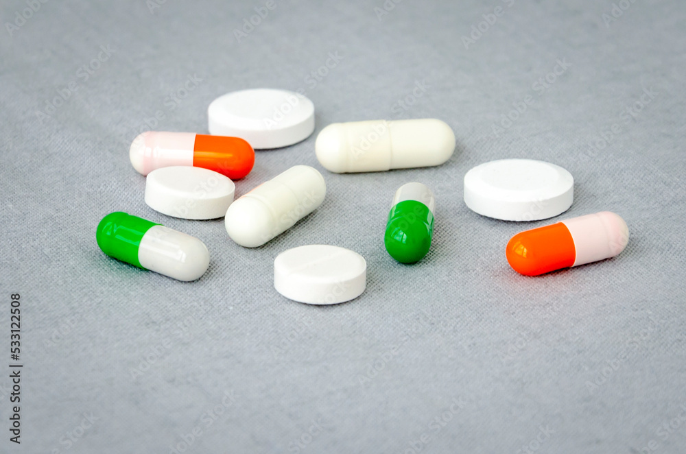 Medication: capsules and pills on a gray background. Medical concept. Close-up Medication: capsules and pills on a gray background. Medical concept. Close-up