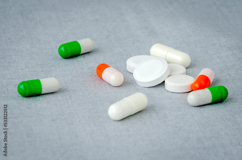 Medication: capsules and pills on a gray background. Medical concept. Close-up Medication: capsules and pills on a gray background. Medical concept. Close-up