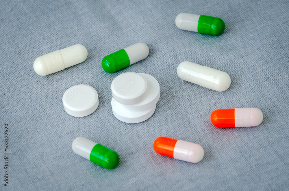 Medication: capsules and pills on a gray background. Medical concept. Close-up Medication: capsules and pills on a gray background. Medical concept. Close-up