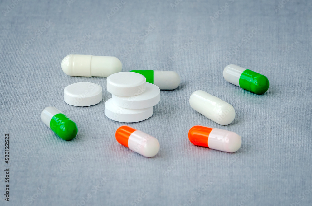 Medication: capsules and pills on a gray background. Medical concept. Close-up Medication: capsules and pills on a gray background. Medical concept. Close-up