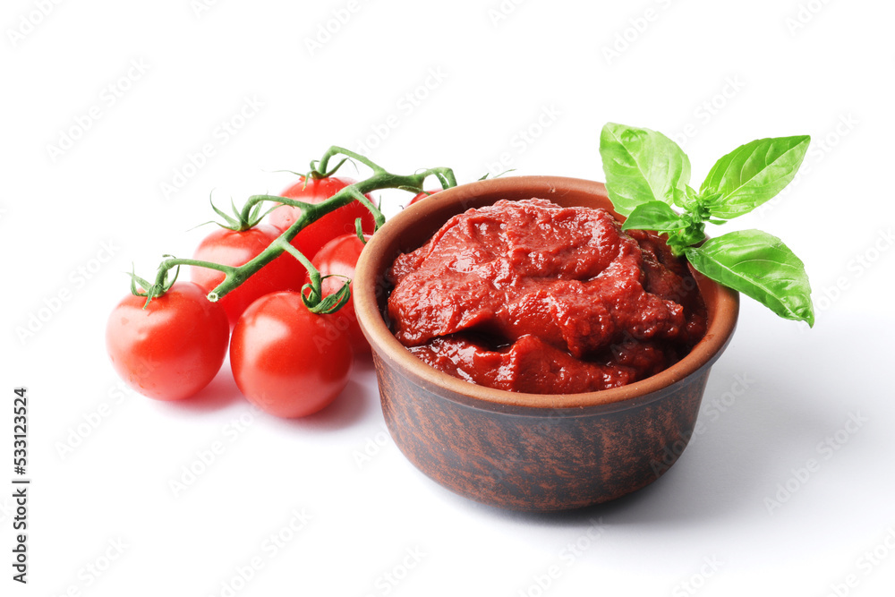 Ripe fresh tomatoes on a white plate, tomato sauce. Cooking ingredient. Fragrant spice green basil. For design.bowl with tomato sauce basil and fresh tomatoes isolated on white background. Ripe fresh tomatoes on a white plate, tomato sauce. Cooking ingredient. Fragrant spice green basil. For design.bowl with tomato sauce basil and fresh tomatoes isolated on white background.