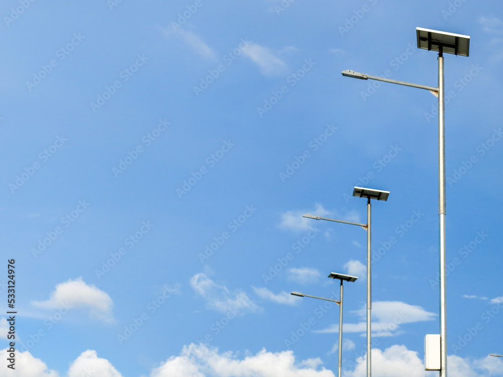 Street lamps with solar cell panel. Bright blue sky on the background. Street lamps with solar cell panel. Bright blue sky on the background.