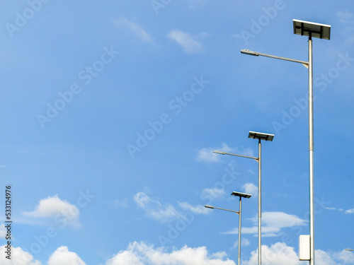 Street lamps with solar cell panel. Bright blue sky on the background.
