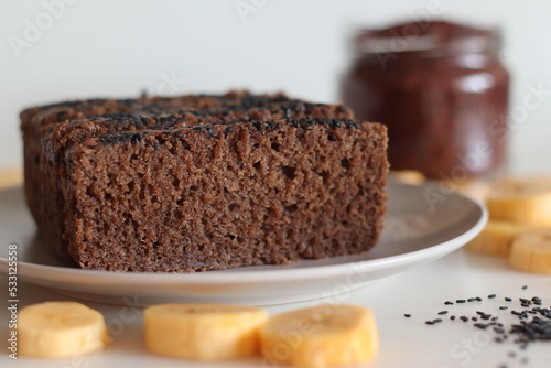 Ragi plantain cake. Gluten free tea cake made of Finger millet flour and pureed ripe plantain, sprinkled with black sesame seeds on top photo