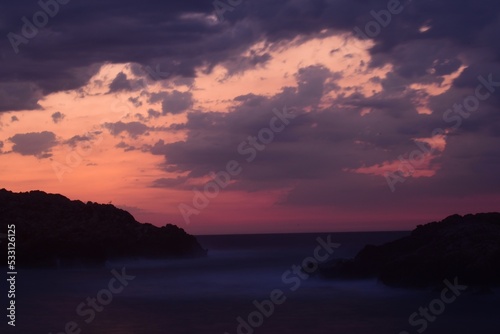 coloured sky over a calm sea